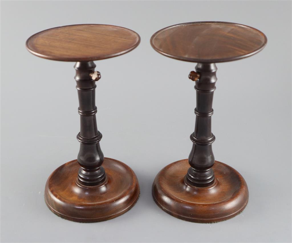 A pair of George III mahogany and ebony adjustable candle stands, height 8.75in.